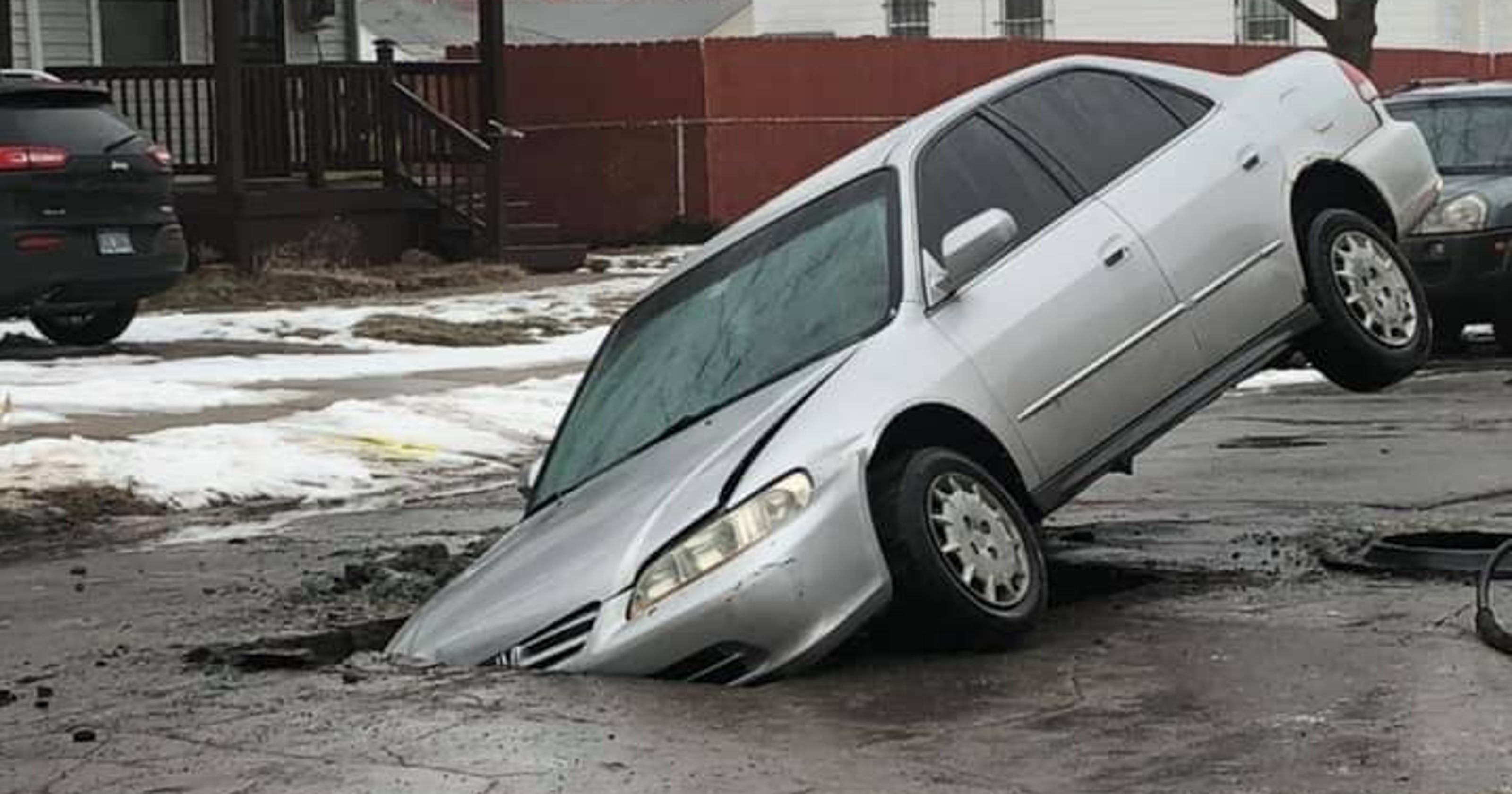 Photos shared of car stuck in huge Hamtramck hole