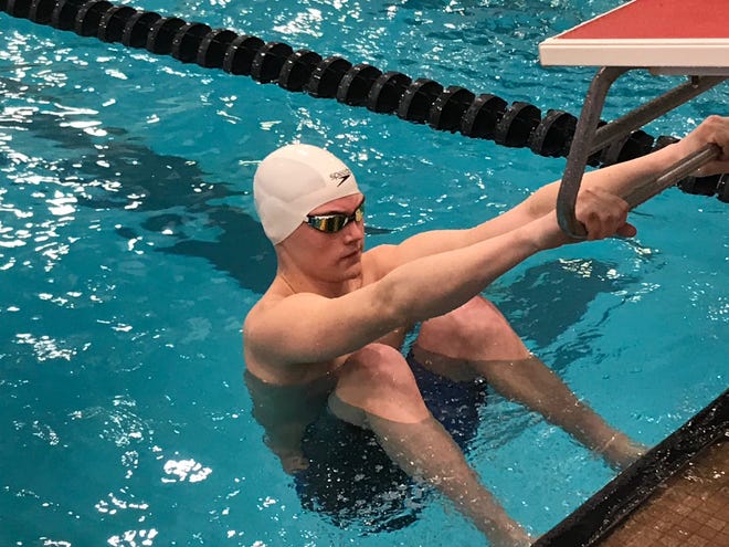Crestview's Ross Kuhn prepares to launch in his heat of the 100 backstroke at the 2019 state swim meet. Kuhn has also competed in the state track meet and this past football quarterbacked the  Cougars into the state playoffs.