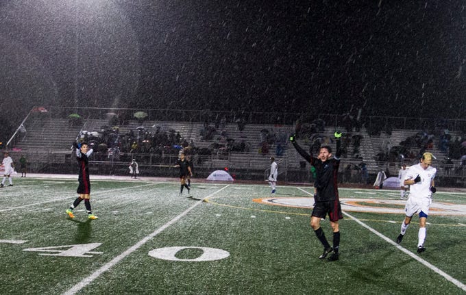 Brophy players celebrate in the rain after they won the 6A State Championship game over Hamilton 3-0 in Gilbert, Thursday, Feb 21, 2019.  