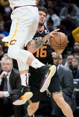 Feb 21, 2019; Cleveland, OH, USA; Phoenix Suns guard Tyler Johnson (16) is fouled by Cleveland Cavaliers forward Kevin Love (0) during the first half at Quicken Loans Arena. Mandatory Credit: Ken Blaze-USA TODAY Sports
