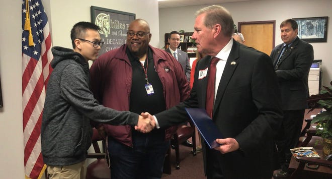 Rep. Neal Dunn, right, visits Chilels junior Andy Jiang, left, to congratulate him on winning the Congressional App Challenge for District 2.