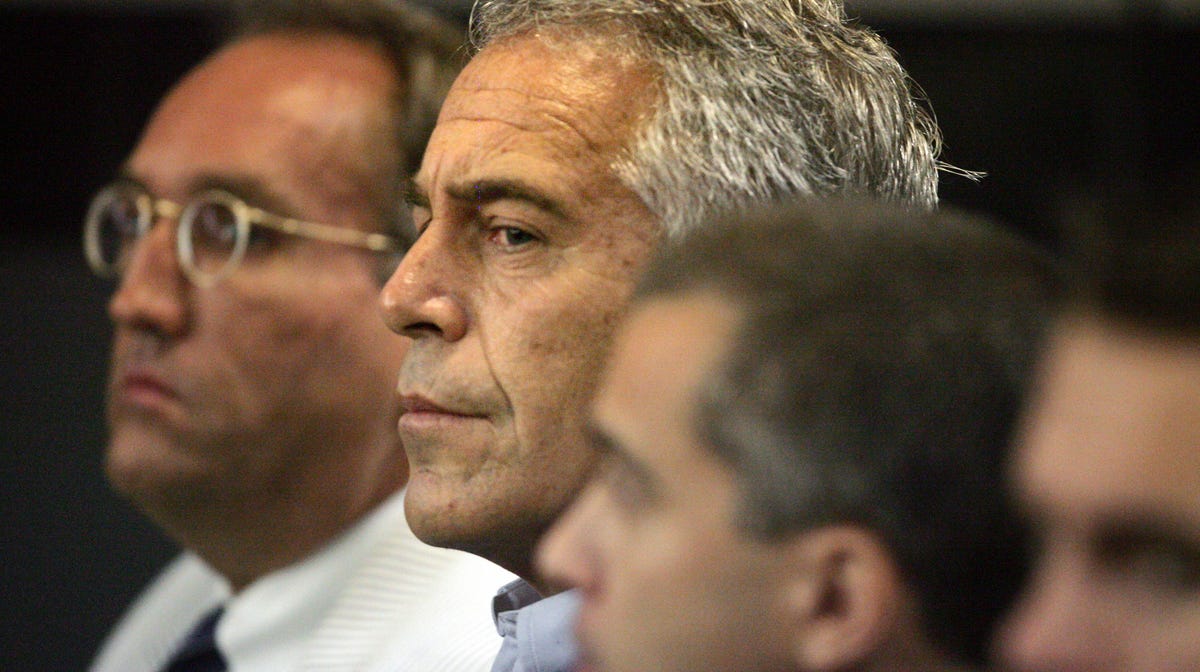 In this July 30, 2008 file photo, Jeffrey Epstein is shown in custody in West Palm Beach, Fla. U.S. District Judge Kenneth Marra ruled Thursday, Feb. 21, 2019, that federal prosecutors violated the rights of victims by secretly reaching a non-prosecution agreement with Epstein, a wealthy financier accused of sexually abusing dozens of underage girls.