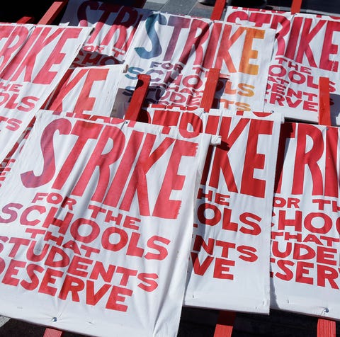 Picket signs are shown as teachers, students and...