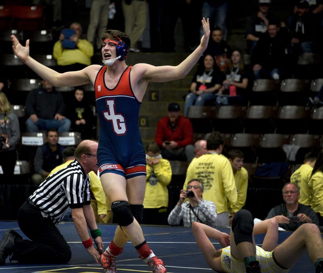 Hayden Rhoades of Westland John Glenn celebrates after he pinned Paul Corder of Hartland in the second period of a 189-pound match Friday.