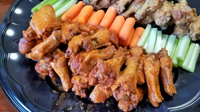 A platter of buffalo and garlic parm wings from Wingz & Thingz, with carrots, celery sticks and ranch dip.