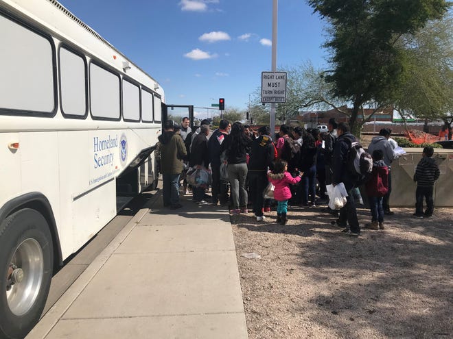 U.S. Immigration Customs Enforcement agents drop off a group of migrant families at a Greyhound station in Phoenix on Feb. 23, 2019.