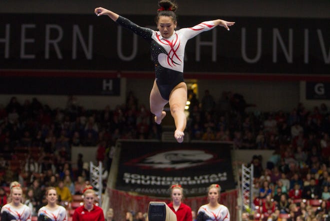 SUU's Shylen Murakami jumps in her balance beam routine during the Flippin' Birds' 196-195.400 win over the No. 17 BYU Cougars on Friday, Feb. 22, 2019.