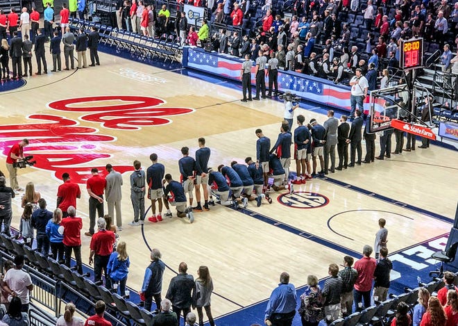 Six Mississippi basketball players take a knee during the national anthem before their game against Georgia on Saturday.