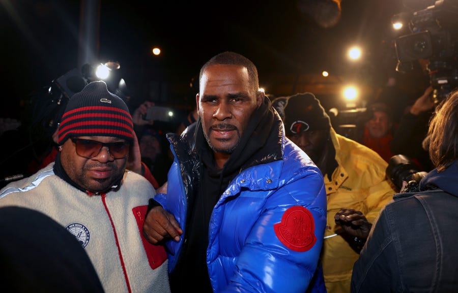 R. Kelly turns himself in at 1st District police headquarters in Chicago on Friday night.