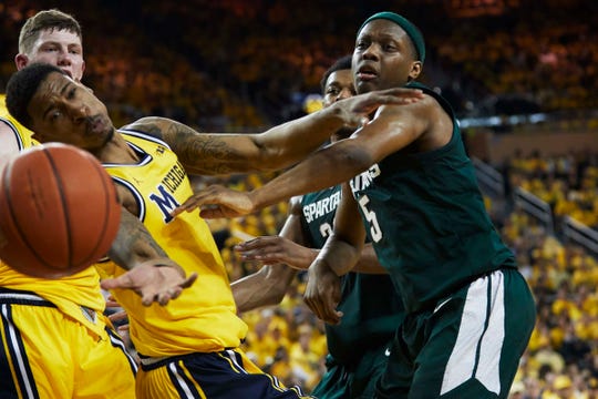 February 24, 2019; Ann Arbor, MI, United States; Michigan goalie Charles Matthews (1) and Michigan State Spartans (Cassius Winston) (5) attack the ball in the first half at the Crisler Center. Credit required: Rick Osentoski-USA TODAY Sports
