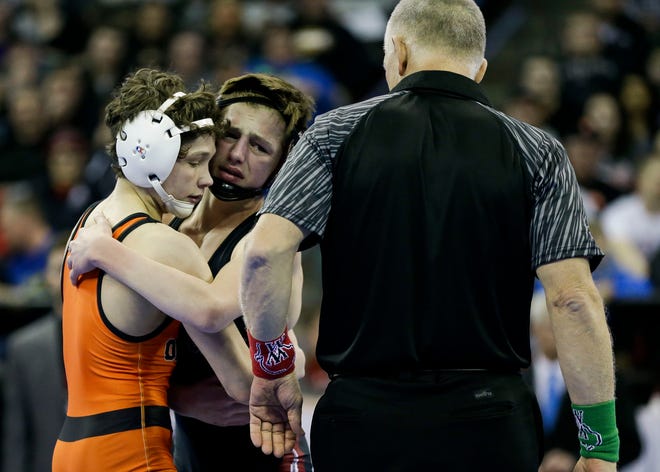 Winneconne's Caleb Meunier congratulates Stanley-Boyd/Owen-Withee's Blaine Brenner after the Division 2 106-pound championship match Saturday during the WIAA state wrestling tournament at the Kohl Center in Madison.