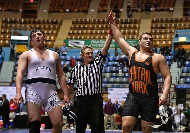 Central's Michael Wolfgram, right, has his hand raised in victory after winning the 285-pound weight class over Dallastown's Raymond Christas at the 2019 District 3 Class 3-A Individual Championships at the Hersheypark Arena. In 2019, both the 3-A and 2-A events were held at Hersheypark Arena. In 2020, the 3-A event will be held at Spring Grove, while the 2-A event will be at Central Dauphin East.