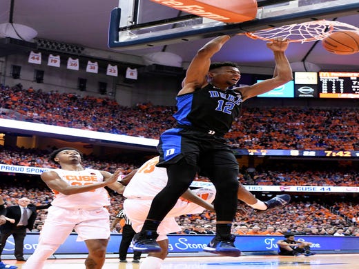 Feb 23, 2019; Syracuse, NY, USA; Duke Blue Devils forward Javin DeLaurier (12) dunks the ball as Syracuse Orange forward Elijah Hughes (33) looks on in the first half at the Carrier Dome. Mandatory Credit: Mark Konezny-USA TODAY Sports