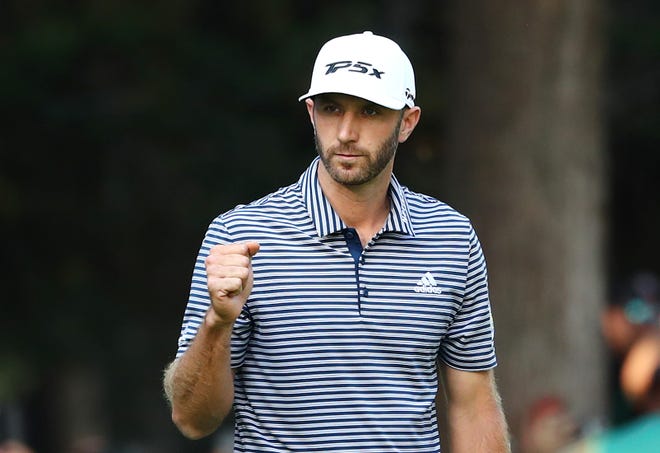 Dustin Johnson of the United States celebrates on the 18th green after making a par to win.