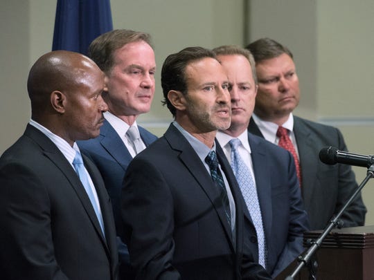 Special Assistant Attorney General Noah Hall, center, speaks during a  June 2016 press conference about about the Flint water crisis investigation.