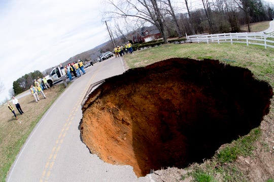 A large sinkhole on Greenwell Road in Powell, Tennessee on Tuesday, February 26, 2019. The sinkhole is estimated to be around 20 feet deep.