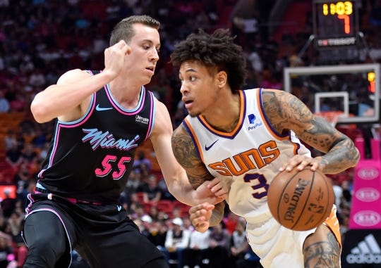 February 25, 2019; Miami, Florida, United States; Phoenix Suns striker Kelly Oubre Jr. (3) dribbles the ball while Miami Heat striker Duncan Robinson (55) defends himself during the first half at the American. Airlines Arena. Mandatory Credit: Steve Mitchell-USA TODAY Sports