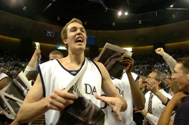 Nevada's Nick Fazekas celebrates with fans after Nevada beat Utah State, 70-63 in overtime, to win the WAC Tournament title in 2006.