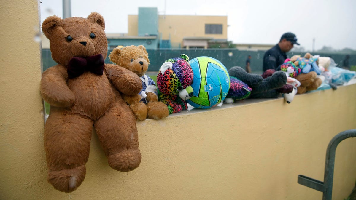 A guard walks by toys placed for migrant children.