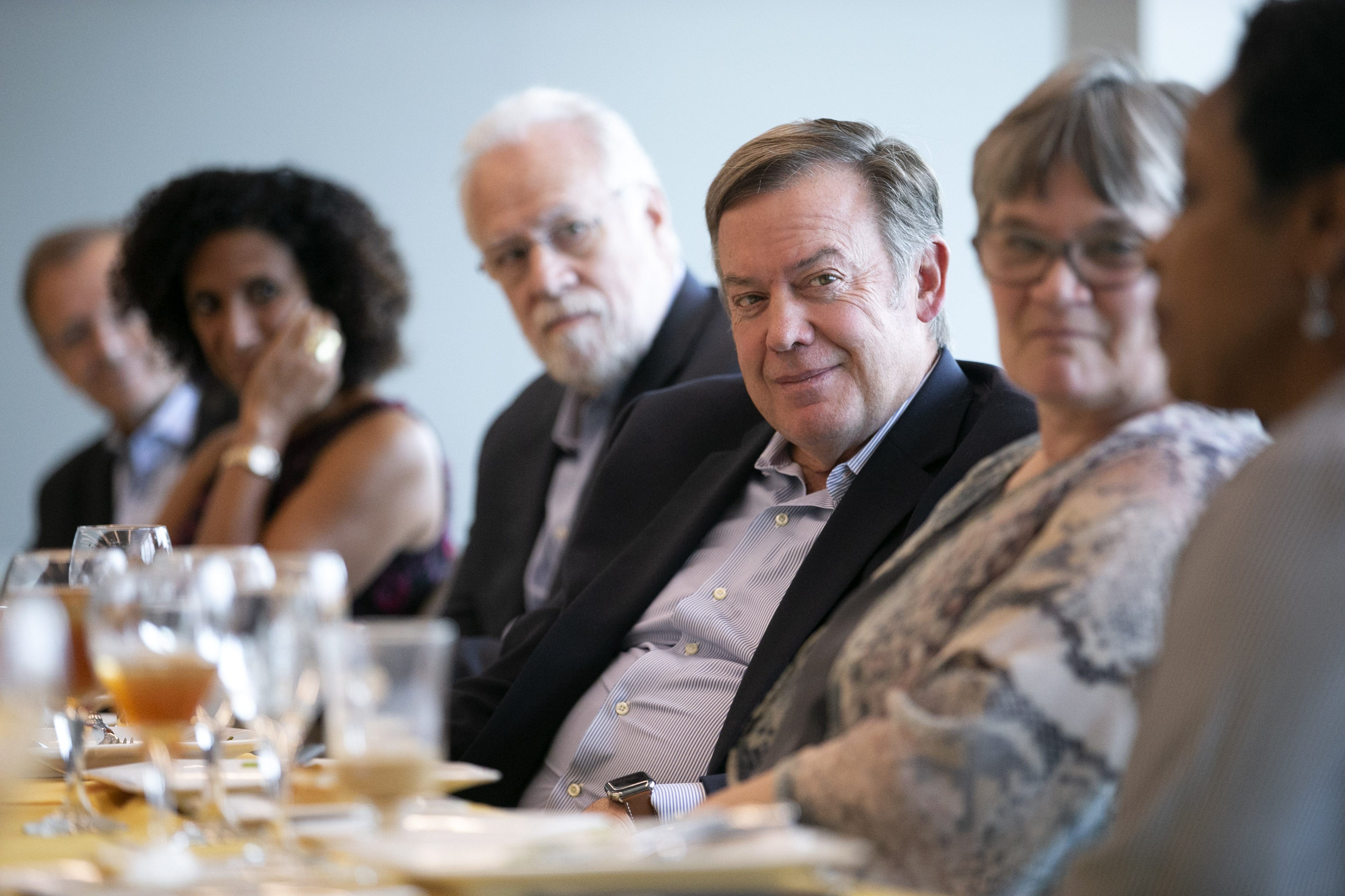 ASU President Michael Crow (center) listens during luncheon for new ASU faculty on the ASU Tempe campus on Oct. 16, 2018.