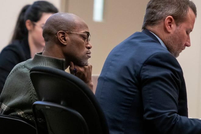 Quinn James, left, listens during Assistant Kent County Prosecutor Kellee Koncki's closing argument during his murder trial at the Kent County Courthouse in Grand Rapids, Mich., on Wednesday, Feb. 27, 2019. (Cory Morse/The Grand Rapids Press via AP)