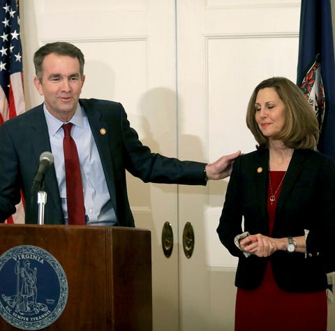 Virginia Gov. Ralph Northam, left, with his wife...