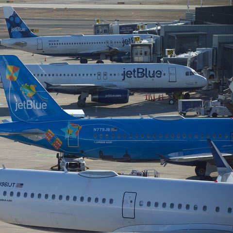 JetBlue Airbus jets line Terminal 5 at New York Jo