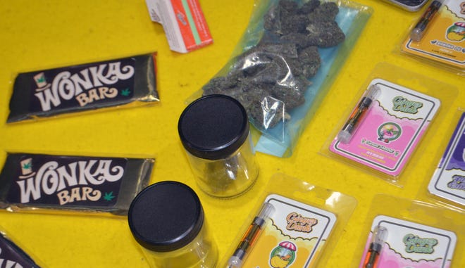 Marijuana in various forms, including dried flower, edibles and concentrates, is displayed for sale at a black market 