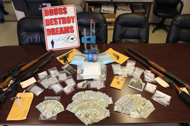Four people, including a teacher at Jim Allen Elementary School, were arrested Friday and an array of narcotics and guns were seized during the early-morning raid.