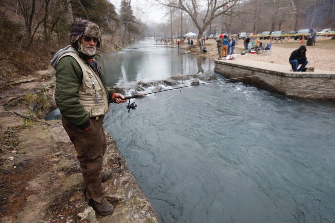 Paul Scott, of Neosho, waits for a fish to strike his lure on opening day of trout season at Roaring River State Park on Friday, Mar. 1, 2019.