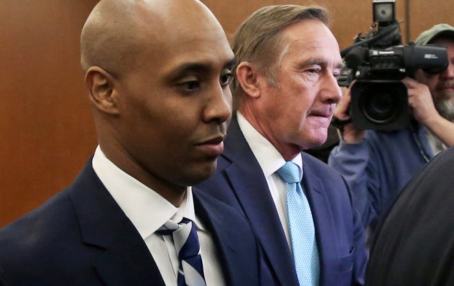 Mohamed Noor, left, former Minneapolis police officer, leaves the Hennepin County Government Center in Minneapolis Friday, March 1, 2019 with attorney Peter Wold after a hearing to address several pretrial motions.