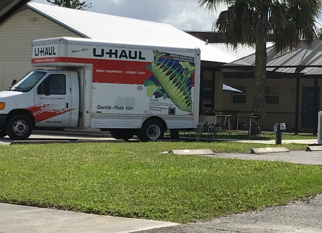 A U-Haul truck with school desks is parked at 880 NW River Shores in Martin County on Friday. Barnabas Christian Academy plans to temporarily hold classes in the two-bedroom apartment starting next week.