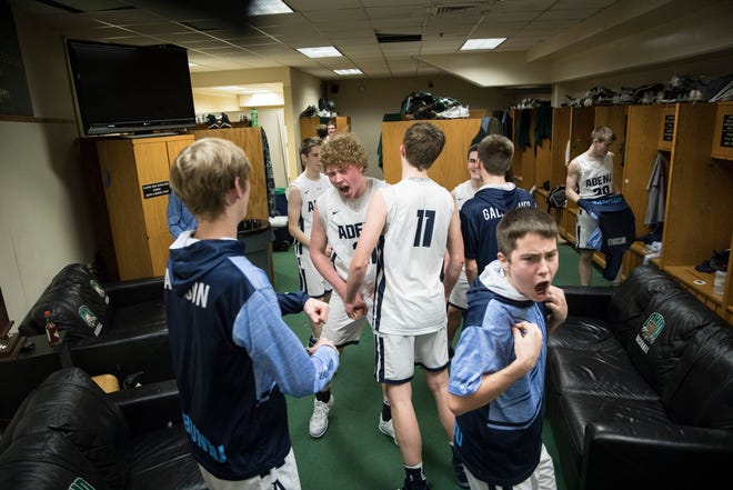 Senior Caleb Foglesong celebrates with his teammates after defeating the Ironton Fighting Tigers Saturday night in a Division III district semifinal game at Ohio University’s Convocation Center in Athens, Ohio, on March 2, 2019.