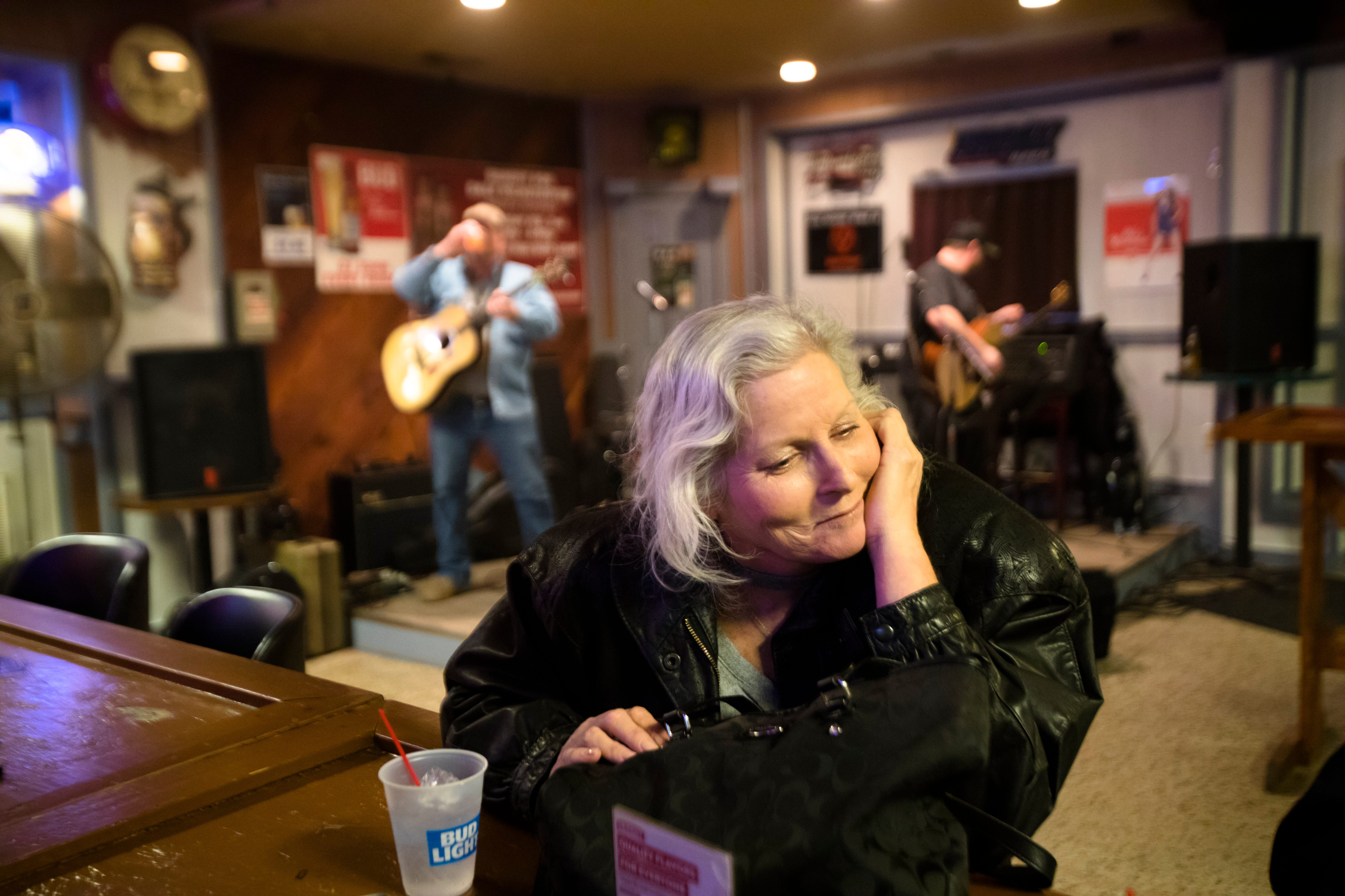 Kathy Stevens listens to music while attending a benefit for her at Hillbilly Heaven in Middletown. Stevens has suffered from breast cancer and ovarian cancer. She now battles liver disease.