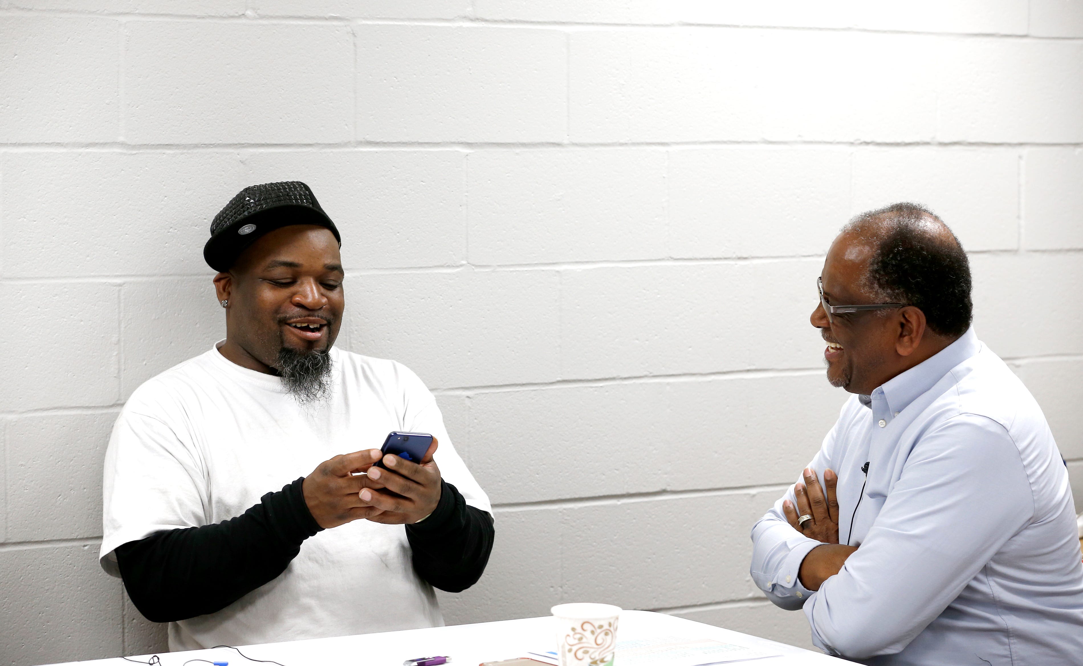 Michael Bailey, 65, right, career counselor, talks with Antoine Delon Durham, 37,  at the resource center of the Robert "Sonny" Hill Community Center in Middletown. Durham is rushing to fill out paperwork and arrange a ride so he can make his new job official before someone else takes it.