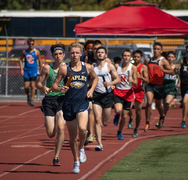 Naples High School's Brady Gibson leads the pack in a relay in the 55th Eagle Invitational track and field meet at Naples High School on Saturday.