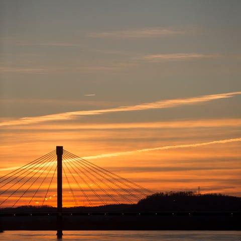 A sunrise silhouettes the US Grant Bridge in...
