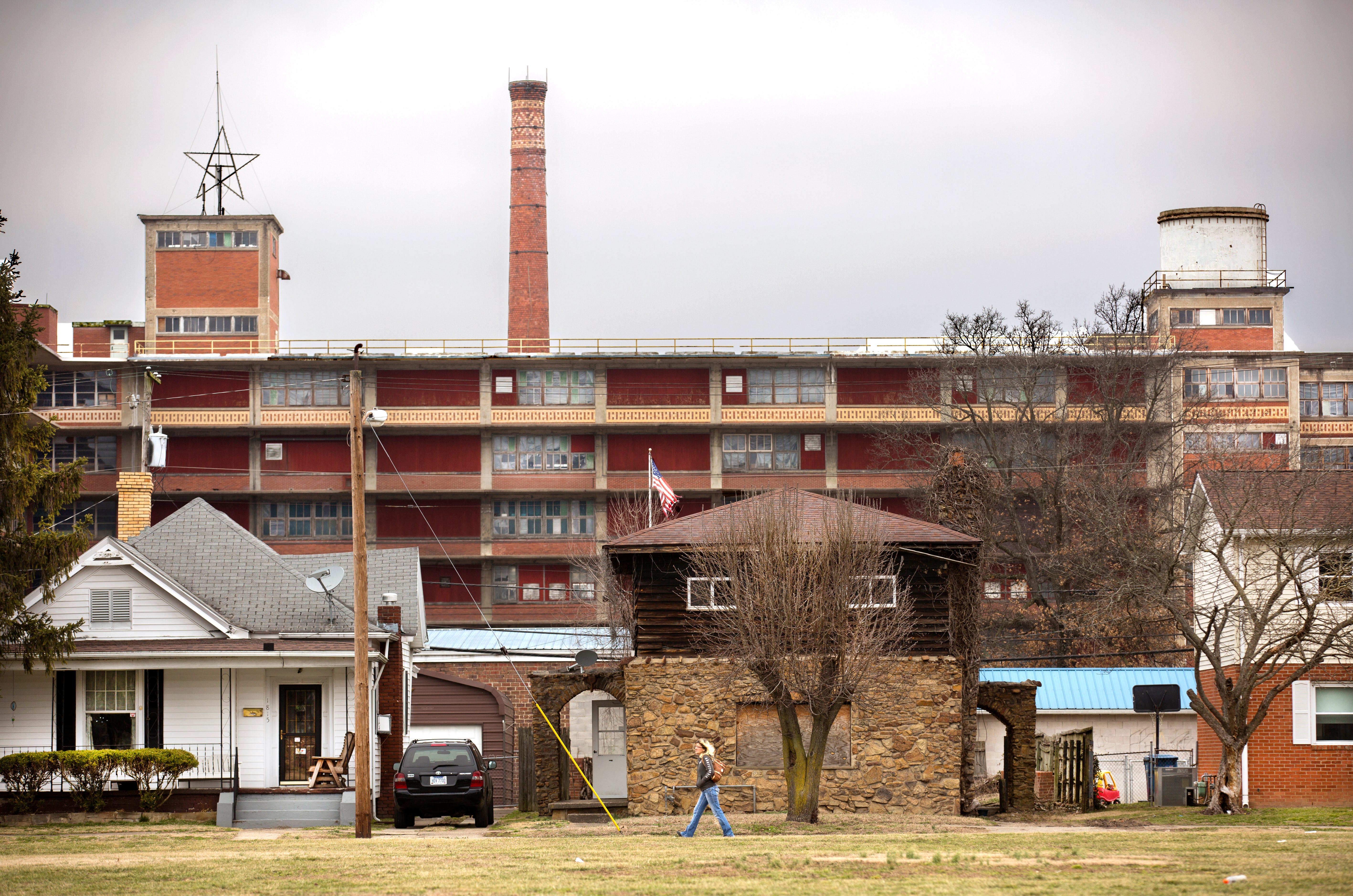 An old shoe manufacturing building that now houses Sole Choice, a maker of shoe and foot care products, looms over a low income neighborhood in Portsmouth, Ohio.