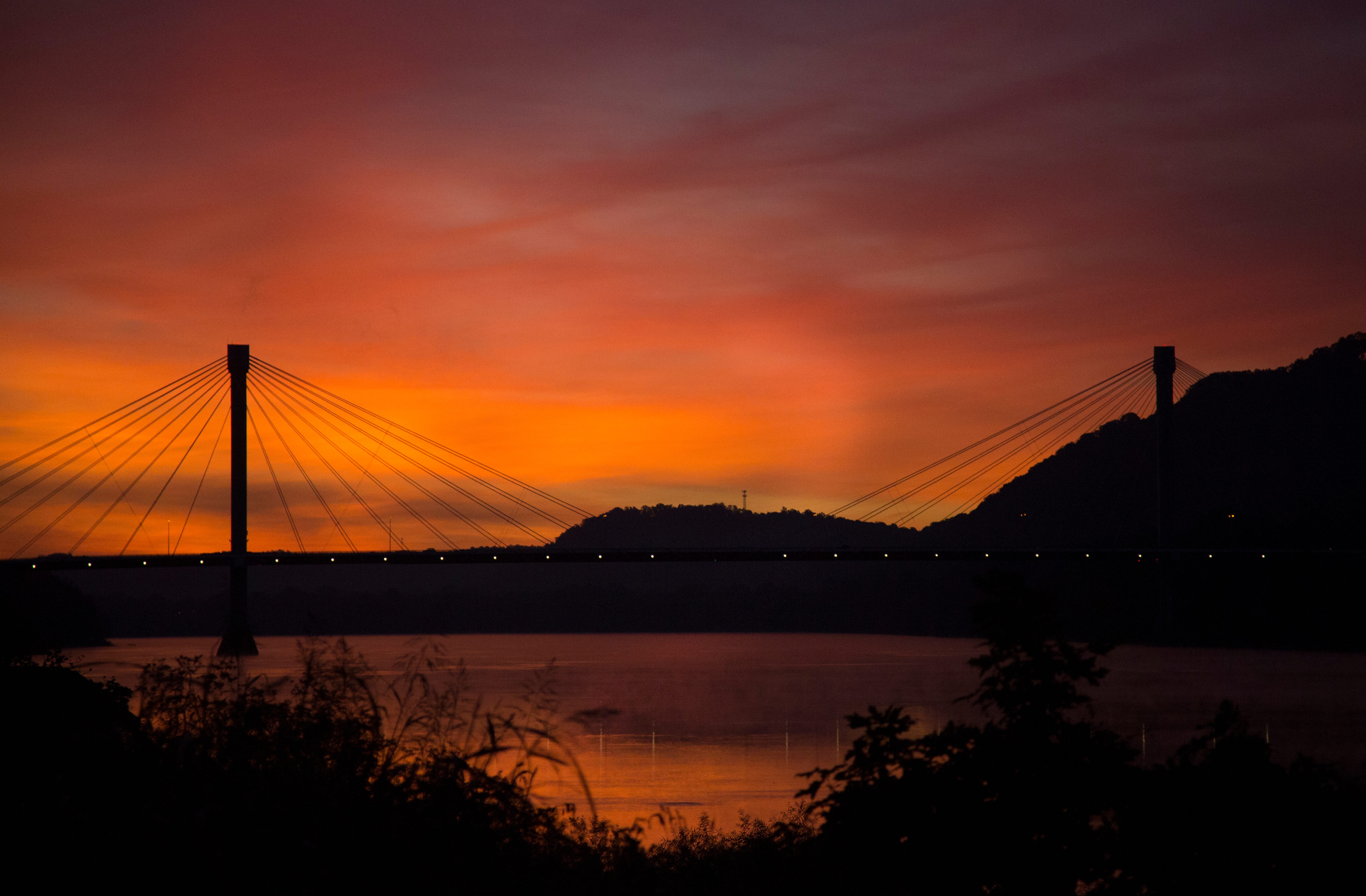 A sunrise silhouettes the US Grant Bridge, which crosses the Ohio River and connects Portsmouth, Ohio to northeastern Kentucky.