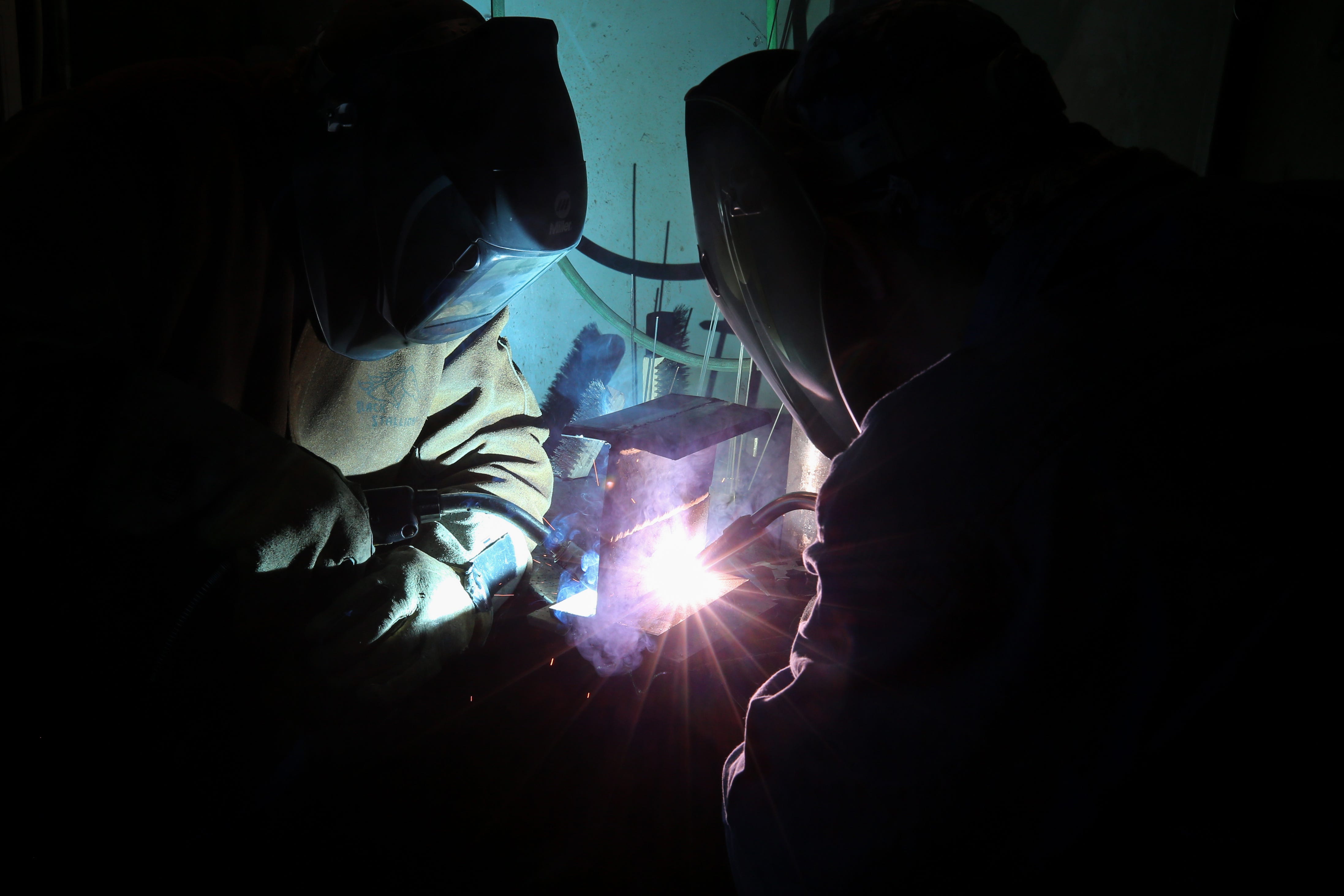 Eli Owsley, 34, left, and Ryan Taylor, 32, right, both students at Elite Welding Academy, work on a buddy weld, in Fairfield.