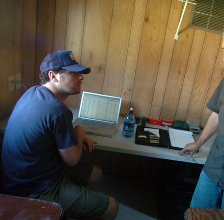 Jonathan Mayers, left, of Superfly Productions and Ashley Capps meet briefly to discuss business. Both are equal partners in the organizing and promoting of the annual Bonnaroo music festival.