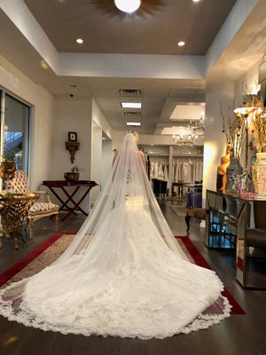 Gina Doloresco ordered this lacy, high-fashion wedding gown with a mermaid silhouette, a sweetheart neckline and a long train at Lillian Lottie Couture in Scottsdale. But the store closed suddenly, leaving her without a dress after paying more than $3,000.