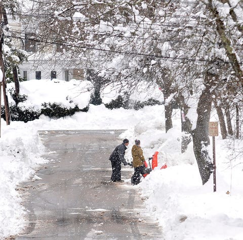 Neighbors dig out a driveway on Rockhill Street...