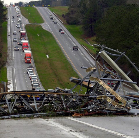 A fallen cell tower lies across U.S. Route 280...