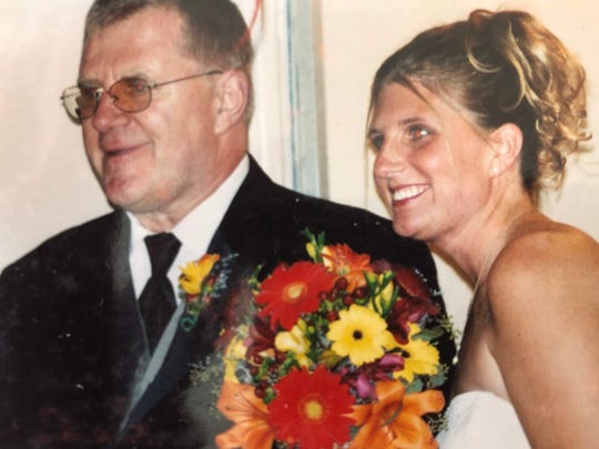 Kimberly McDonald of Richmond, Wisc. is shown with her father Gerry Middag on her wedding day in 2003. Middag died by suicide in 2010 while suffering from Parkinson's disease and after he was also diagnosed with Lewy body dementia.