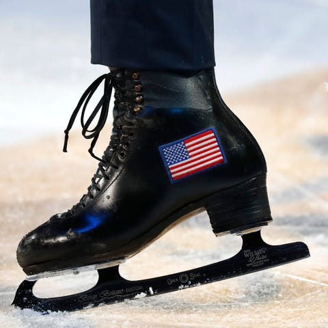 Ice skates with an American flag are shown during...