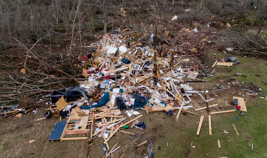 Debris litters a yard the day after a deadly tornado damaged a home in Beauregard, Alabama.