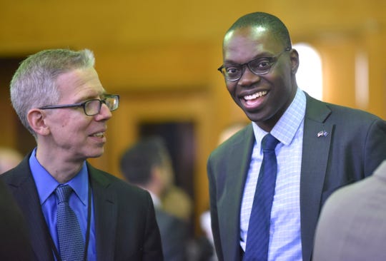 Michigan Department of Health and Human Services Director Robert Gordon, left, talks with Lt. Gov. Garlin Gilchrist before the meeting.