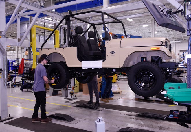 Jacob Myers,19, installs tires on a 2019 Roxor at the end of the assembly line at the Mahindra automotive plant in Auburn Hills.
