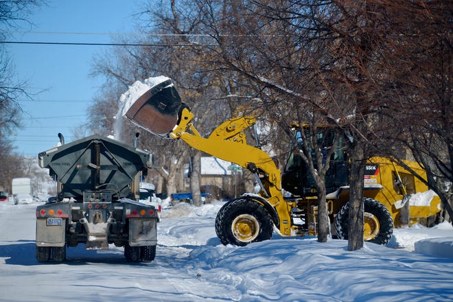 A work crew from Dr. Lawn removes a winters worth of snow from the C.M. Russell Museum parking lot on Tuesday morning.
